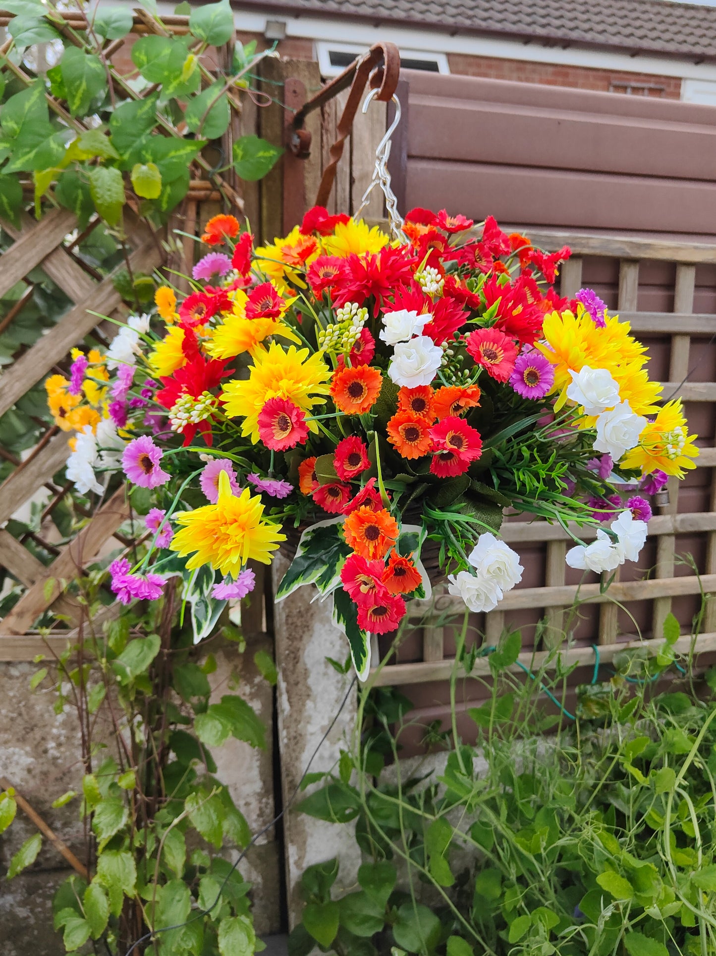 Bright artificial flower hanging basket pub garden 